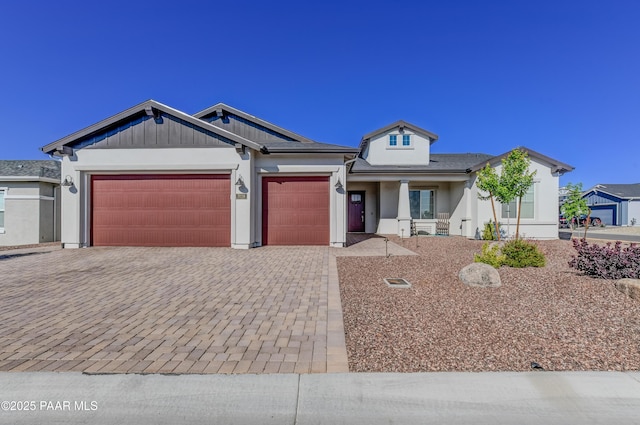 7028 Corral Ct, Prescott, AZ 86305 - view of front facade with an attached garage, decorative driveway, and stucco siding