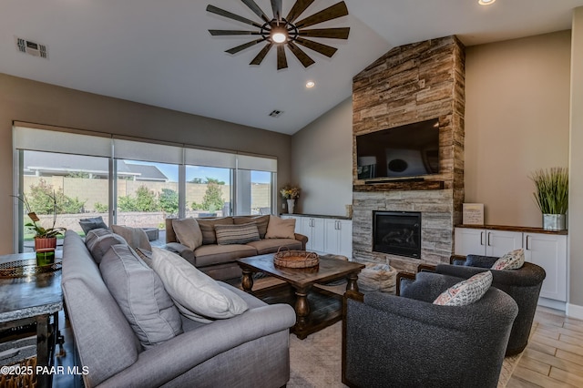 7028 Corral Ct, Prescott, AZ 86305 - living room with ceiling fan, a stone fireplace, light wood finished floors, recessed lighting, and high vaulted ceiling