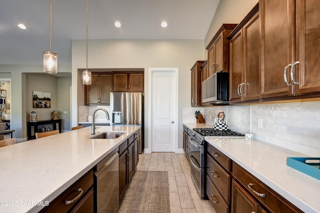 7028 Corral Ct, Prescott, AZ 86305 - kitchen featuring stainless steel appliances, decorative backsplash, decorative light fixtures, recessed lighting, and light stone countertops