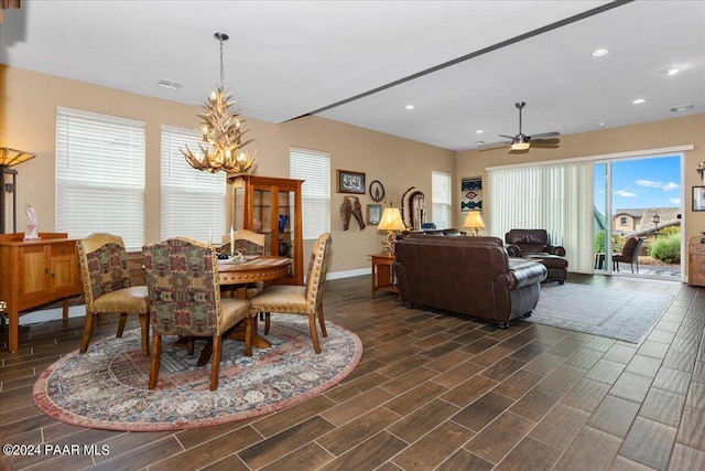 dining space with ceiling fan and dark wood-type flooring