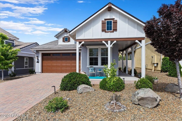 view of front of house featuring covered porch and a garage