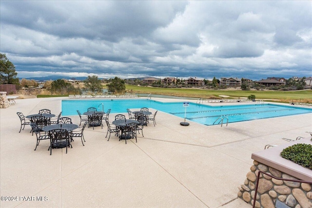 view of swimming pool with a patio