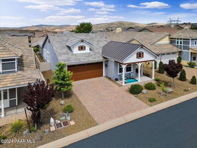 view of front facade with a mountain view and a garage