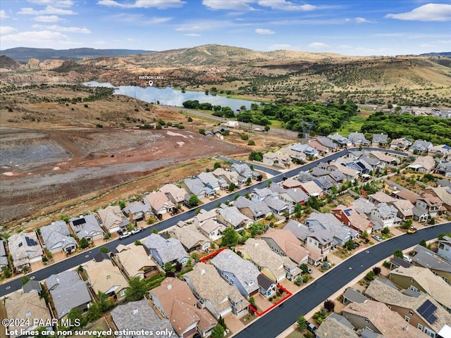 birds eye view of property with a water and mountain view