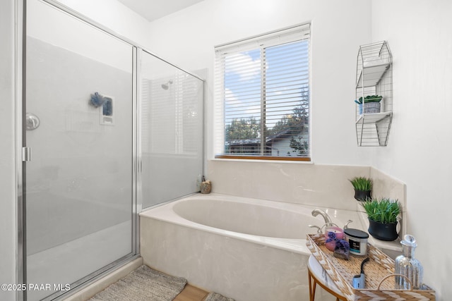 bathroom with shower with separate bathtub