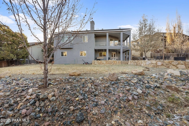 rear view of house featuring a balcony