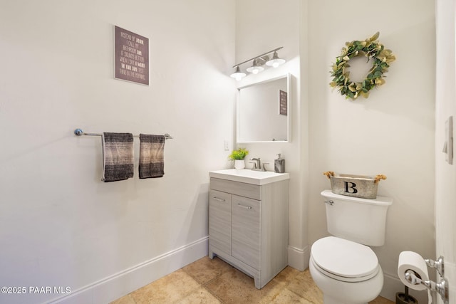 bathroom featuring tile patterned floors, vanity, and toilet