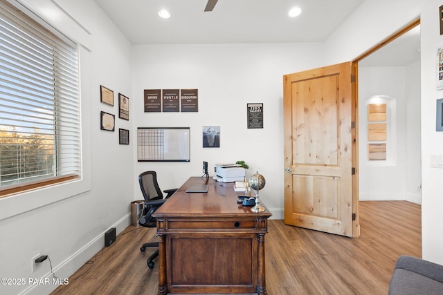 office space with hardwood / wood-style floors, a wealth of natural light, and ceiling fan