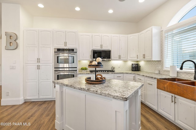 kitchen featuring white cabinetry, stainless steel appliances, and a kitchen island