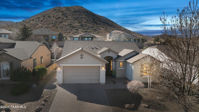 view of front of house with a mountain view and a garage