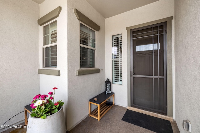 entrance to property featuring stucco siding