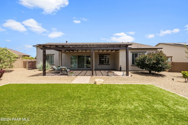 back of house with stucco siding, a pergola, a fenced backyard, a patio, and a lawn