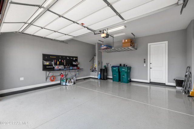 garage featuring baseboards and a garage door opener