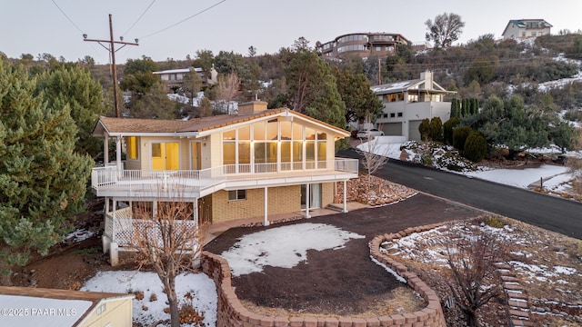 back of property featuring a balcony