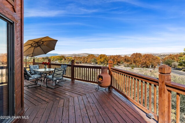 wooden deck featuring a mountain view