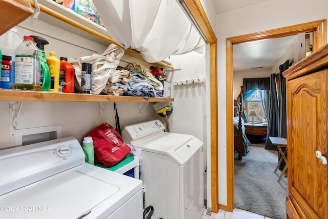 laundry room featuring light carpet and washer and dryer