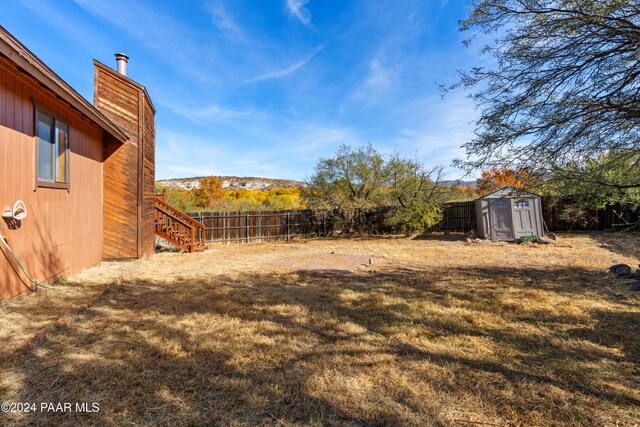 view of yard with a mountain view and a storage unit