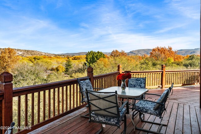 wooden deck with a mountain view