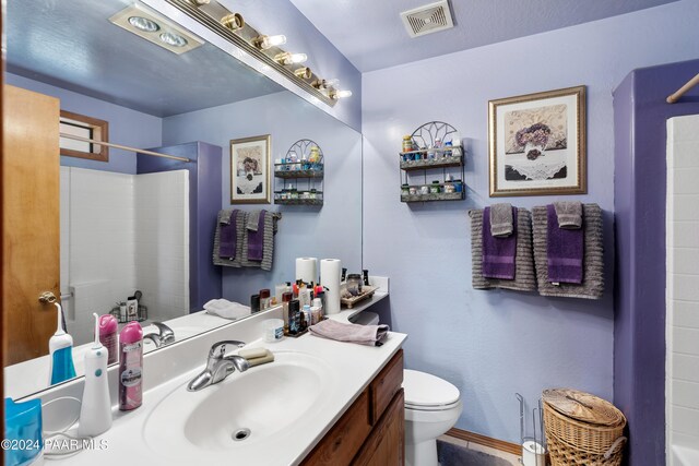 bathroom featuring vanity and toilet