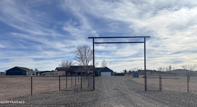 view of road with gravel driveway