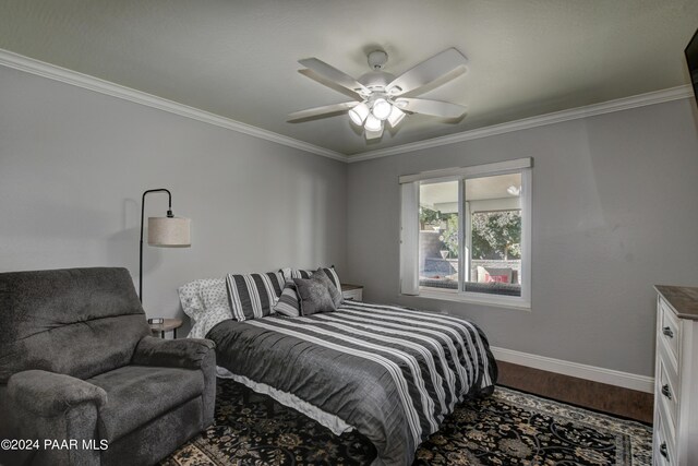 bedroom featuring hardwood / wood-style flooring, ceiling fan, and ornamental molding