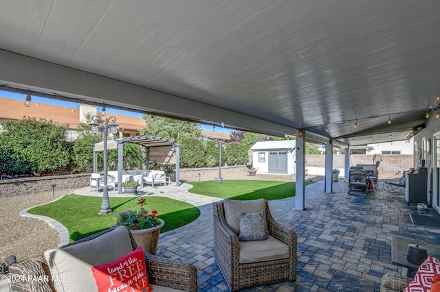 view of patio with outdoor lounge area and a shed