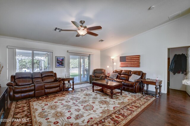 living room with dark hardwood / wood-style flooring, crown molding, ceiling fan, and lofted ceiling