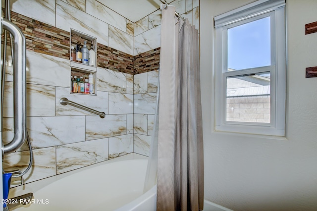 bathroom featuring a wealth of natural light and shower / bath combination with curtain