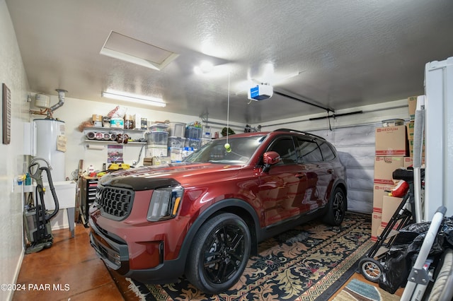 garage with a garage door opener and water heater