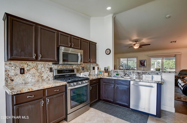 kitchen with kitchen peninsula, stainless steel appliances, and sink