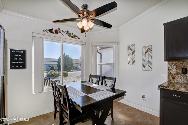 dining area featuring tile patterned floors, ceiling fan, and crown molding