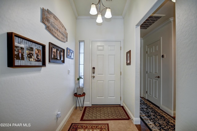 foyer entrance featuring tile patterned flooring, crown molding, and a chandelier