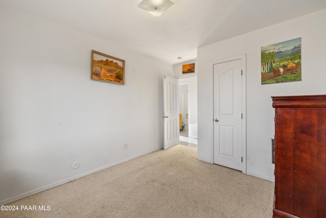 unfurnished bedroom featuring light colored carpet