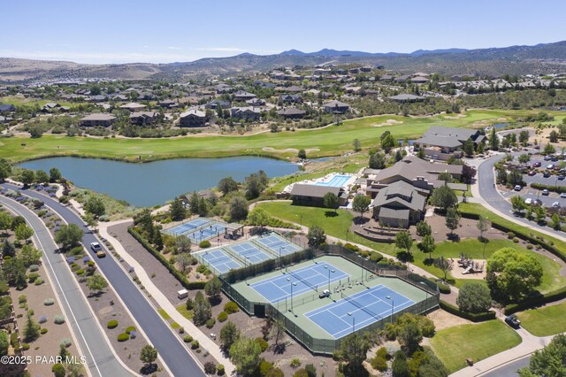 aerial view with a residential view, golf course view, and a water and mountain view