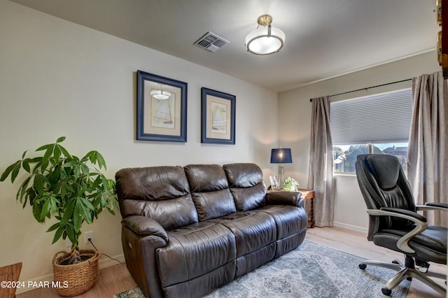 office space with visible vents, baseboards, and wood finished floors