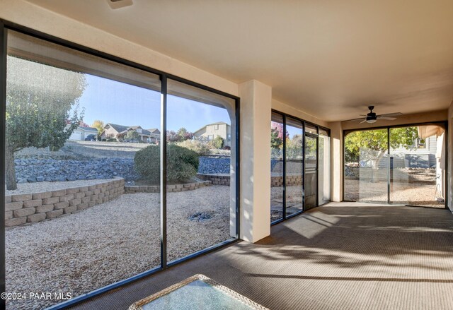 sunroom featuring a ceiling fan