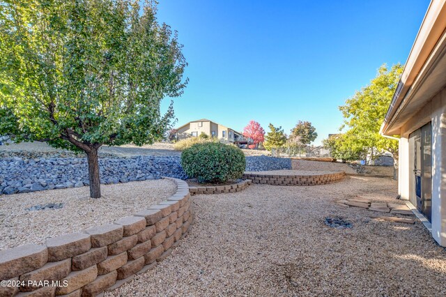 drone / aerial view with view of golf course, a residential view, and a water and mountain view