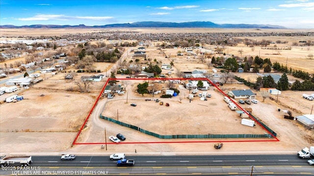 aerial view featuring a desert view and a mountain view