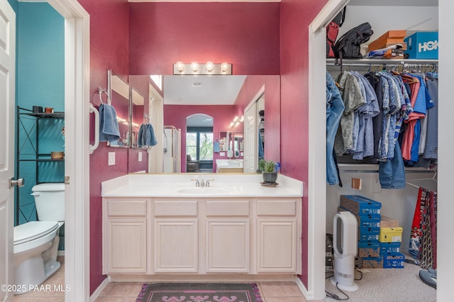 2315 W Desert Willow Dr, Cottonwood, AZ 86326 - bathroom with vanity, a walk in closet, tile patterned floors, and toilet