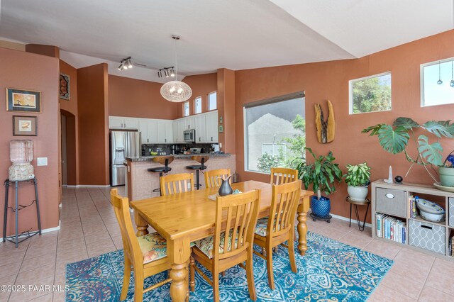 2315 W Desert Willow Dr, Cottonwood, AZ 86326 - dining space with light tile patterned flooring, arched walkways, baseboards, and rail lighting
