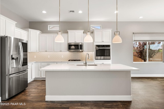 5385 Rocky Vista Dr, Prescott, AZ 86301 - kitchen with stainless steel appliances, tasteful backsplash, plenty of natural light, white cabinets, and recessed lighting