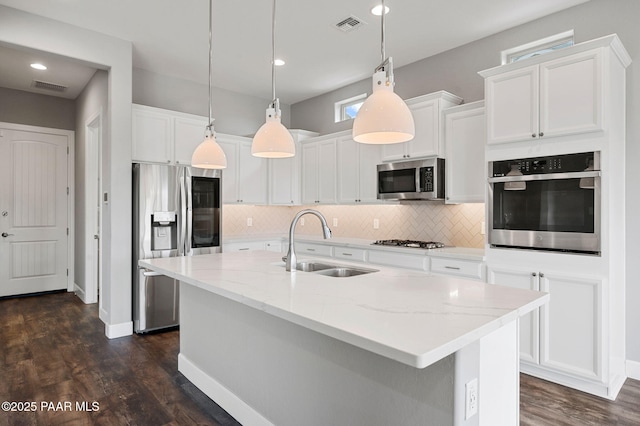 5385 Rocky Vista Dr, Prescott, AZ 86301 - kitchen featuring stainless steel appliances, white cabinetry, backsplash, dark wood-style flooring, and light stone countertops