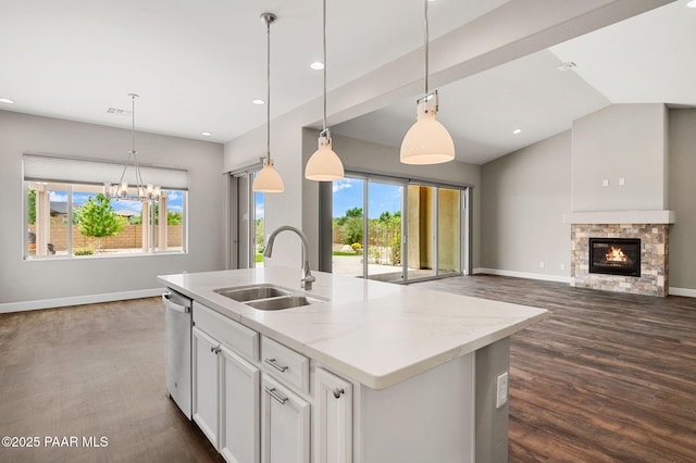 5385 Rocky Vista Dr, Prescott, AZ 86301 - kitchen featuring stainless steel dishwasher, open floor plan, white cabinets, a stone fireplace, and a kitchen island with sink