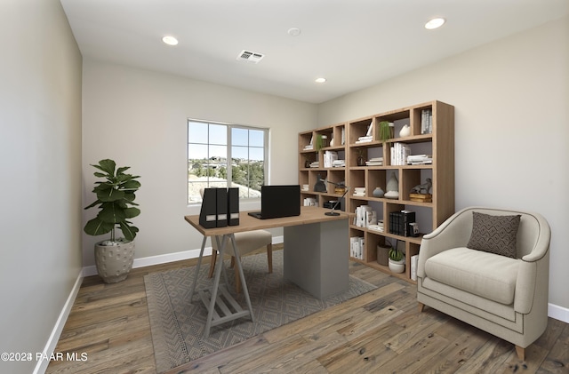 office featuring baseboards, wood finished floors, and visible vents
