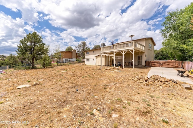 2345 Shinnery Ln, Prescott, AZ 86301 - back of property with a deck, a fenced backyard, a shed, a patio, and a gate