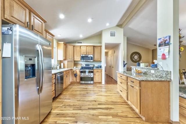 2345 Shinnery Ln, Prescott, AZ 86301 - kitchen featuring stainless steel appliances, light wood-type flooring, lofted ceiling, light stone counters, and light brown cabinetry