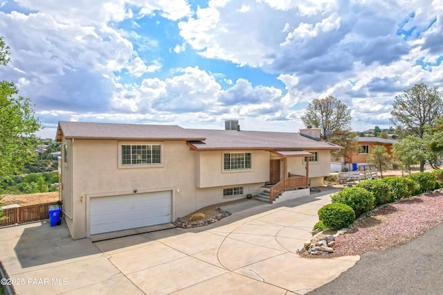 2345 Shinnery Ln, Prescott, AZ 86301 - view of front of house with an attached garage, driveway, stucco siding, a shingled roof, and a chimney