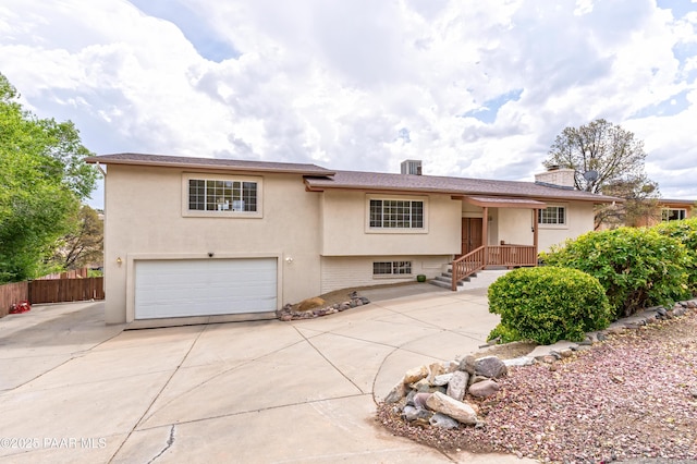 2345 Shinnery Ln, Prescott, AZ 86301 - view of front facade featuring a garage, driveway, stucco siding, and a chimney