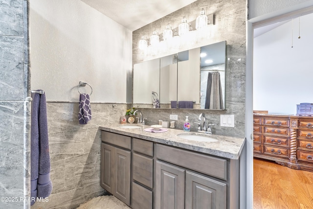 2345 Shinnery Ln, Prescott, AZ 86301 - full bathroom featuring double vanity, tile walls, and wood finished floors