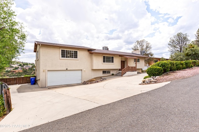 2345 Shinnery Ln, Prescott, AZ 86301 - view of front of house with an attached garage, driveway, stucco siding, and a chimney